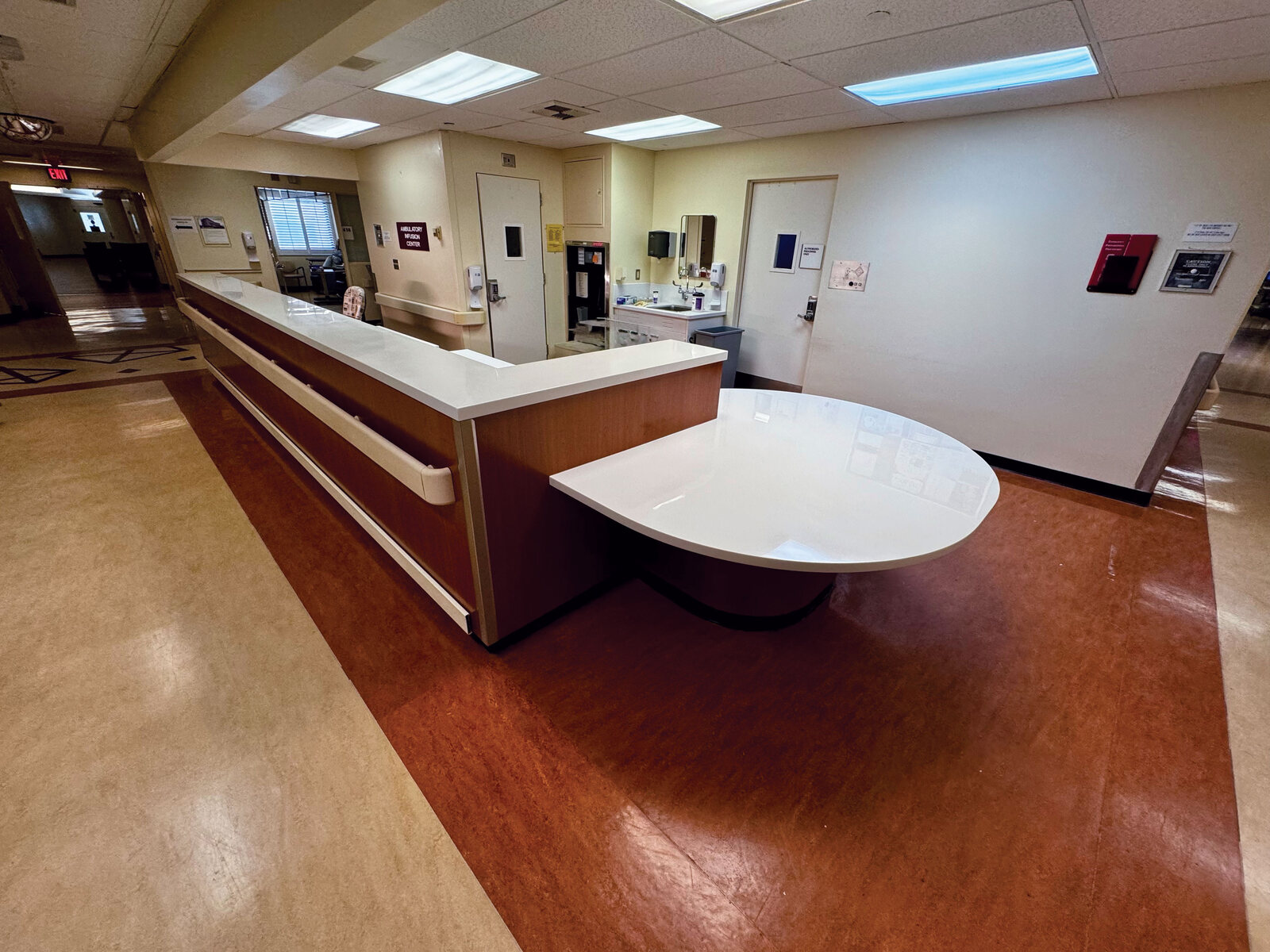 Renovated hospital nurse station with new casework and finishes delivered inside an active facility