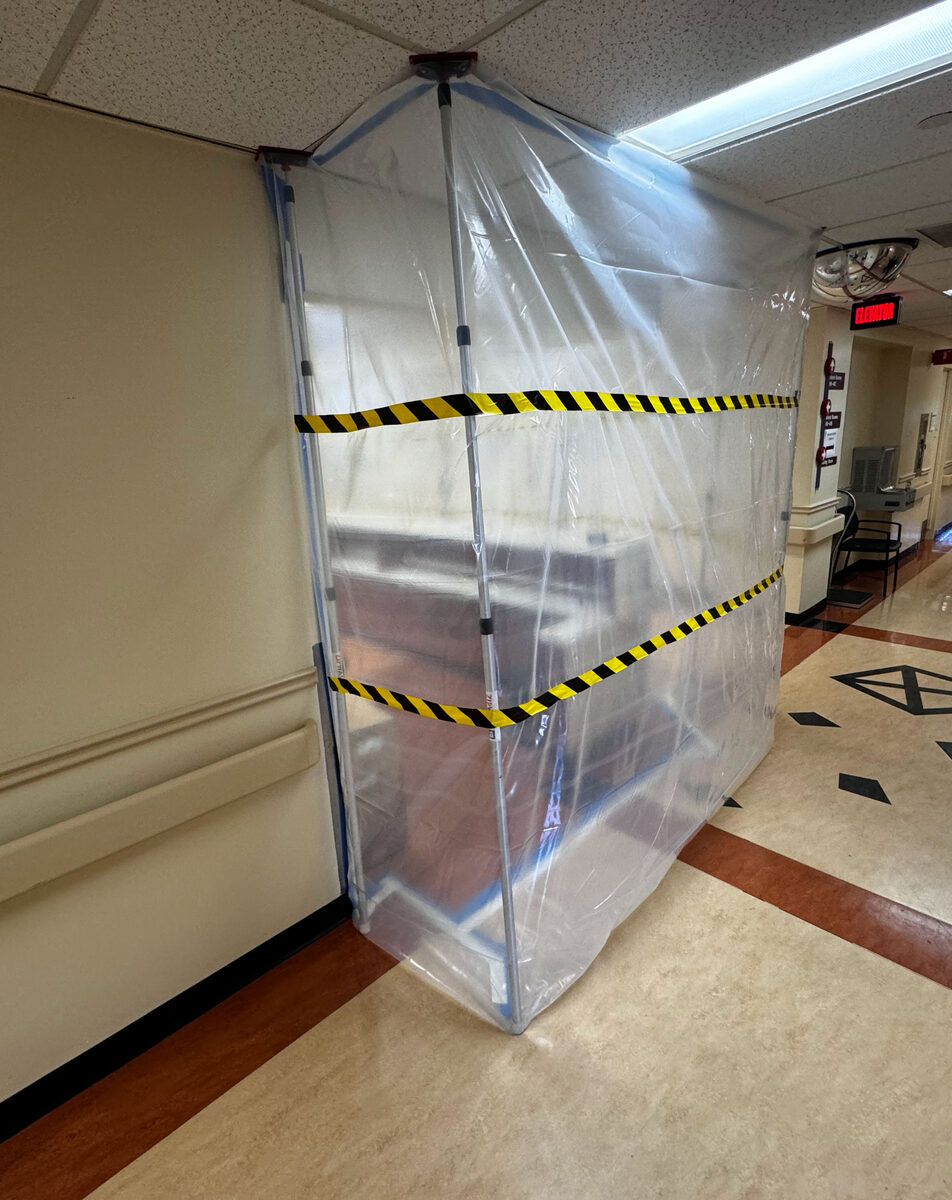 ICRA containment barrier with negative-air filtration in an active hospital corridor